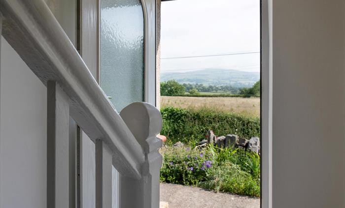 As you step out of the front door you are immediately in the countryside. To your right, you will find a bistro table and two chairs, lovely for a bit